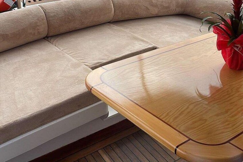 A beige sofa with a wooden table beside it. 4