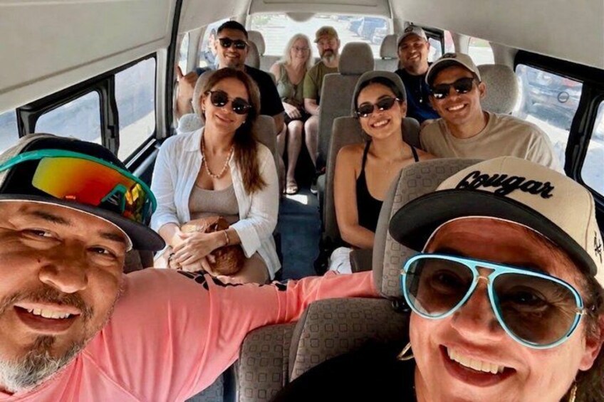 A group of people seated inside a vehicle with a window view. 2