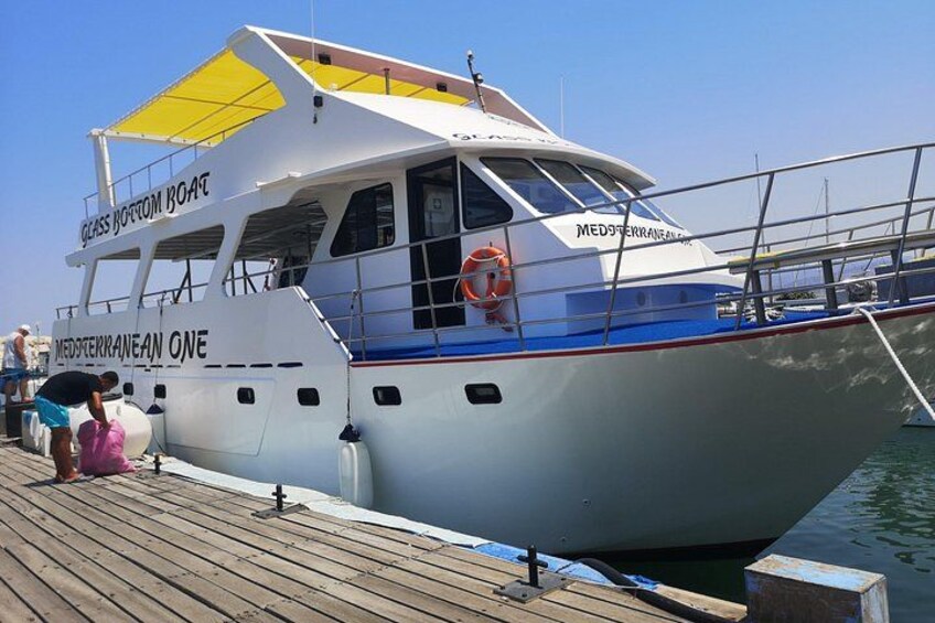 A white boat named 'Mediteranean One' docked at a pier. 2
