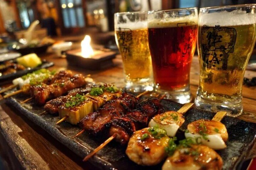 Skewered meats and beer glasses on a wooden table. 3