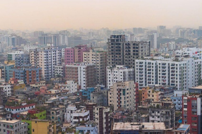 A densely packed urban area with a variety of multi-story buildings, some with visible balconies and windows. 5