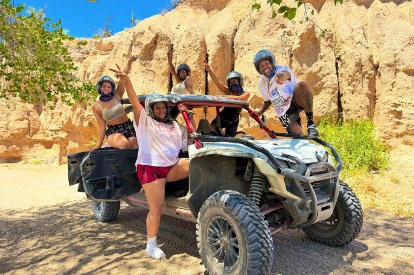 A group of people on an off-road vehicle in a rocky terrain. 4