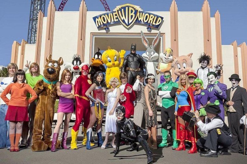 A group of people in costumes in front of a building with a sign that reads 'MOVIE WORLD'. 2
