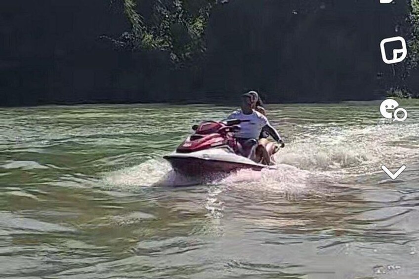 A person riding a jet ski on a body of water. 4