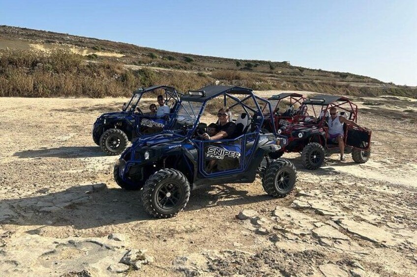 Off-road vehicles on a sandy terrain with a clear sky. 4