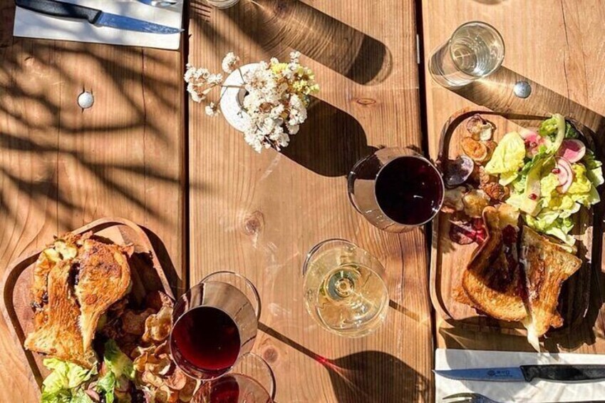 A wooden table with food and drinks. 4