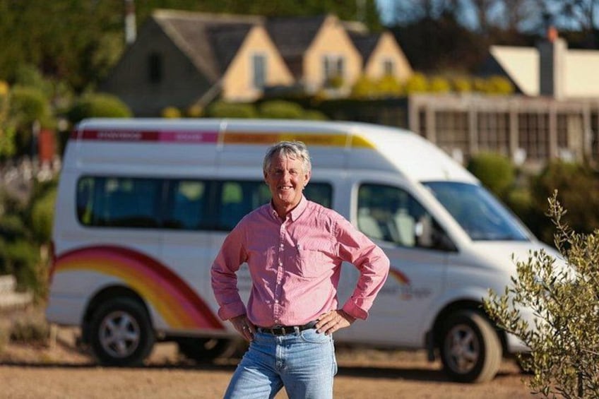 A person standing in front of a white van with a rainbow design. 5