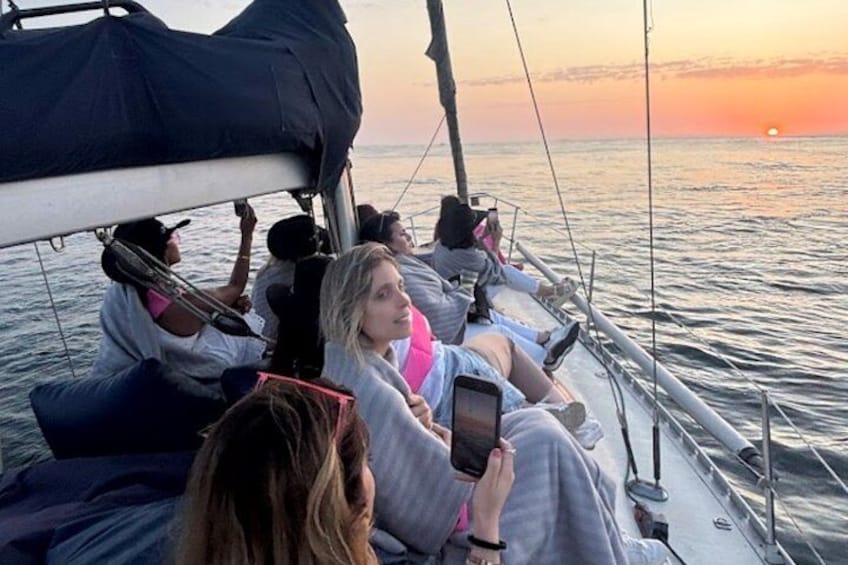 People on a sailboat at sunset. 4