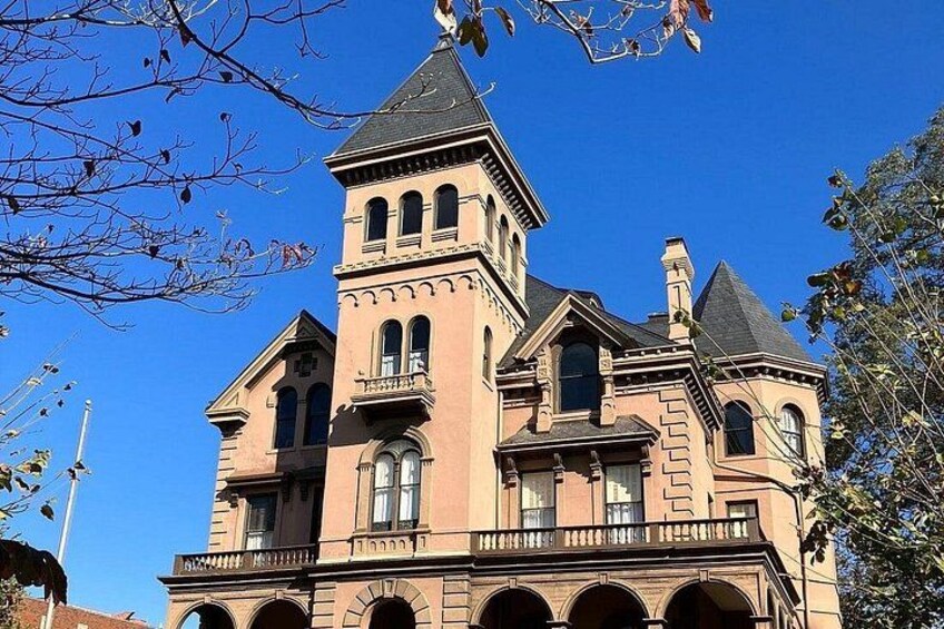 A large, historic building with a prominent tower and arched windows. 2