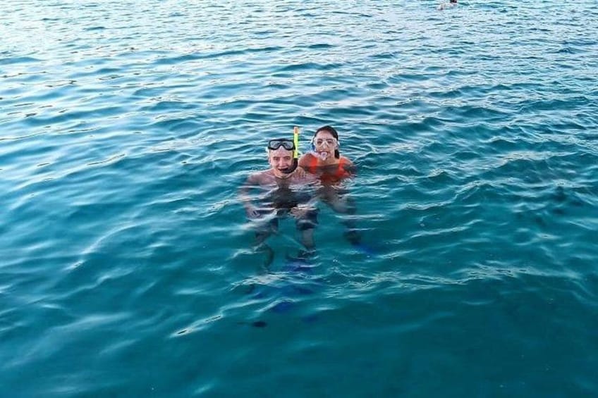 Two people snorkeling in clear blue water. 3