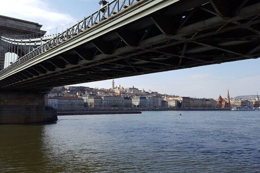 A bridge over a river with a cityscape in the background. 5