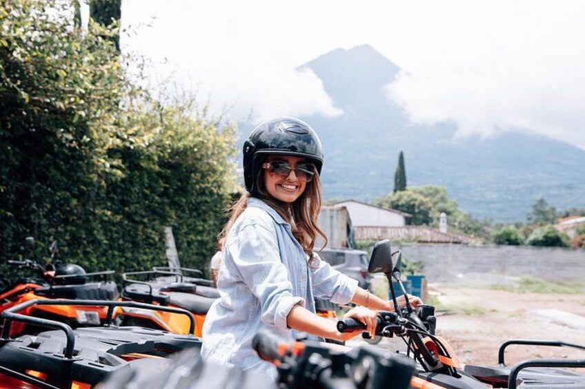 A person on a quad bike with a mountainous landscape in the background. 3