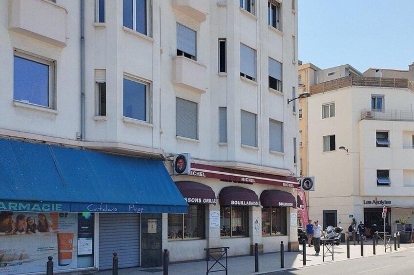 A street with shops, including a pharmacy and a restaurant. 4