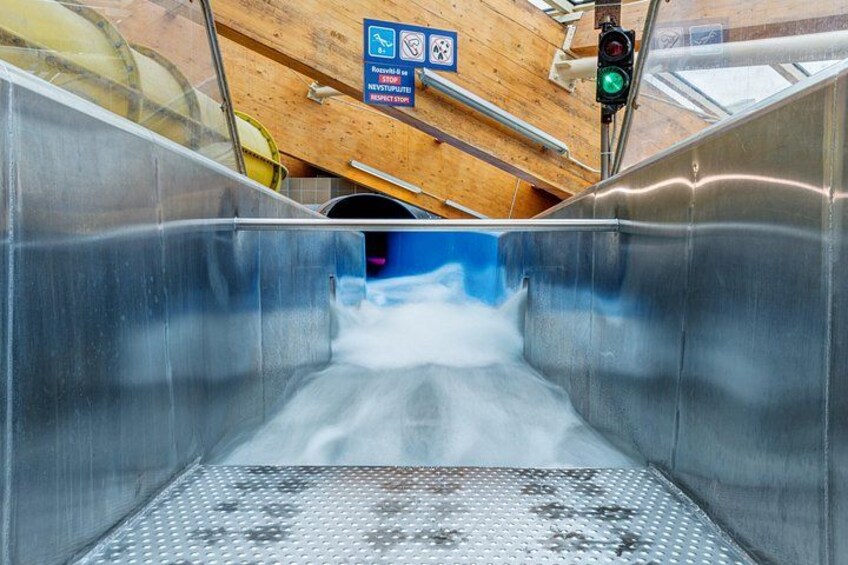 An escalator with a metal handrail and a metal step. 4