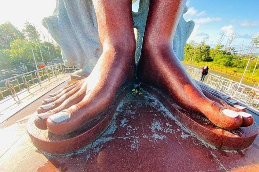 A large sculpture of a human foot and toes. 4