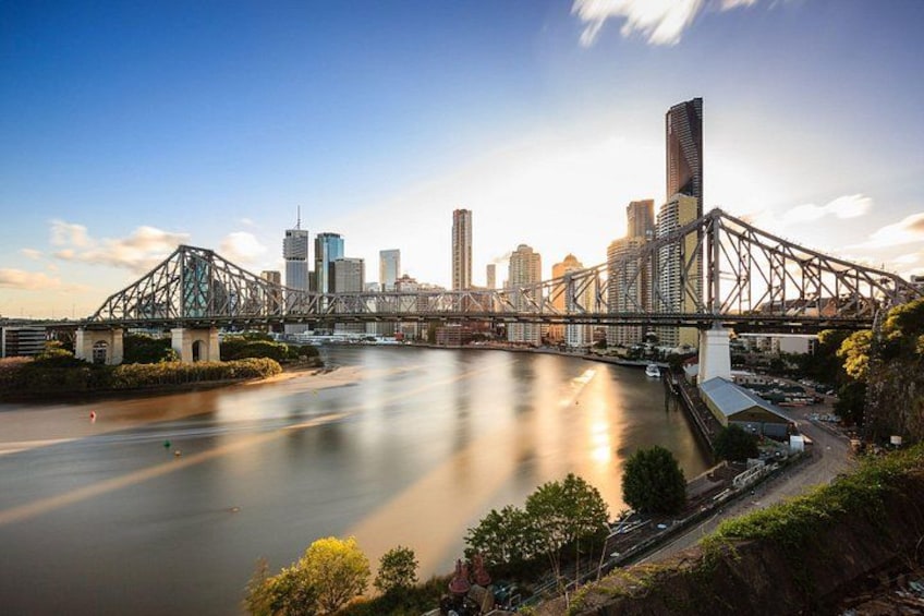 A river with a bridge, city skyline, and buildings. 3