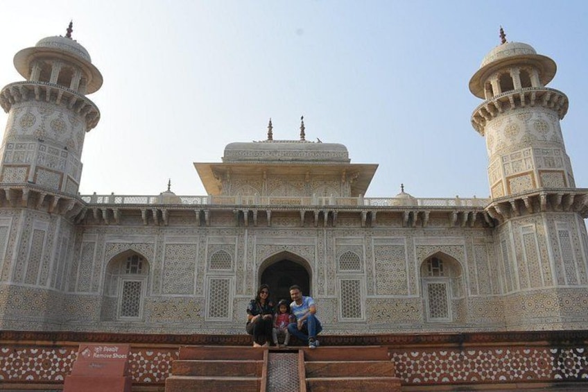 A large, ornate building with two prominent domes and a central archway. 3