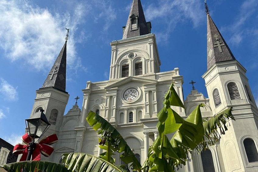 A church with two spires, a clock, and crosses on the towers. 5