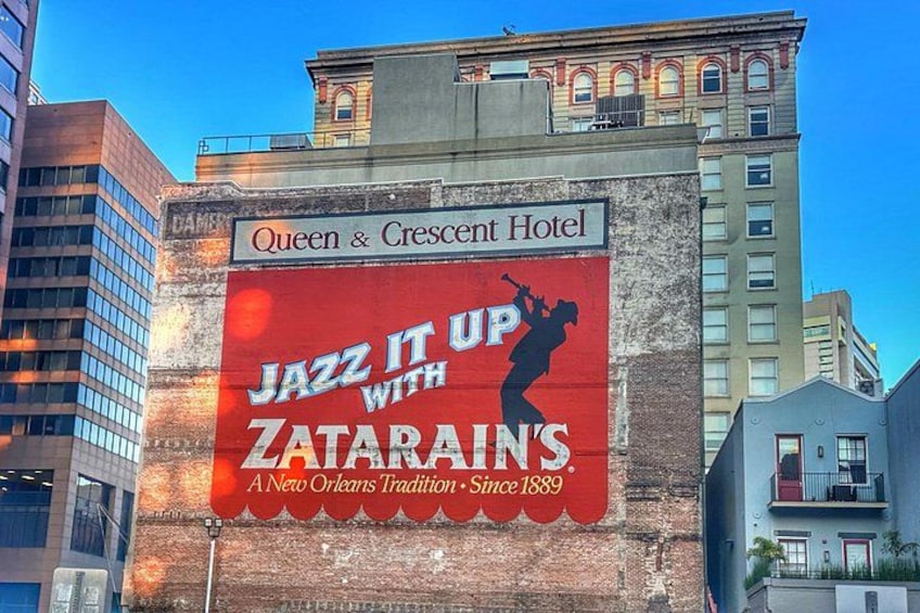 A building with a large billboard advertising Zatarain's jazz music. 4