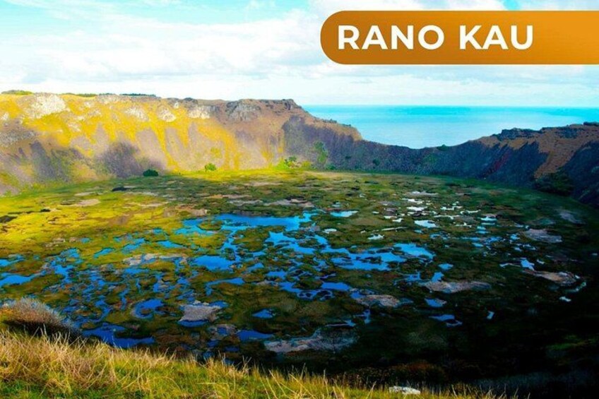 A landscape with a large body of water, green vegetation, and rocky cliffs. 1