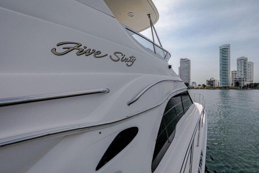 A yacht named 'Five Sway' docked near a city skyline with tall buildings. 4