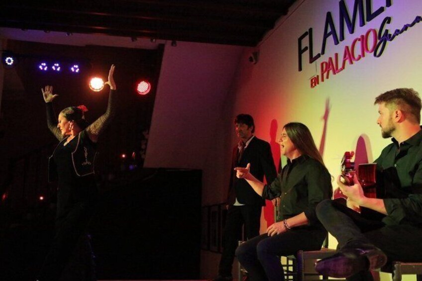 A stage with people, a banner reading 'FLAMEL by PALACIO,' and stage lighting. 4