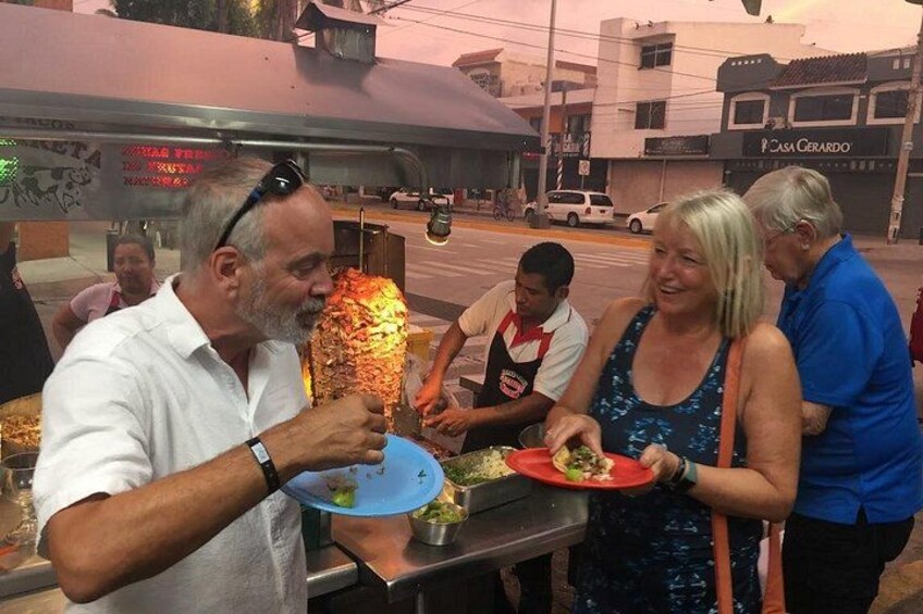 A street food vendor preparing food in an urban setting. 1