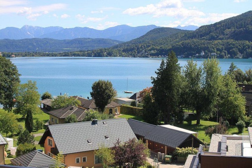 A lake surrounded by houses and mountains. 5