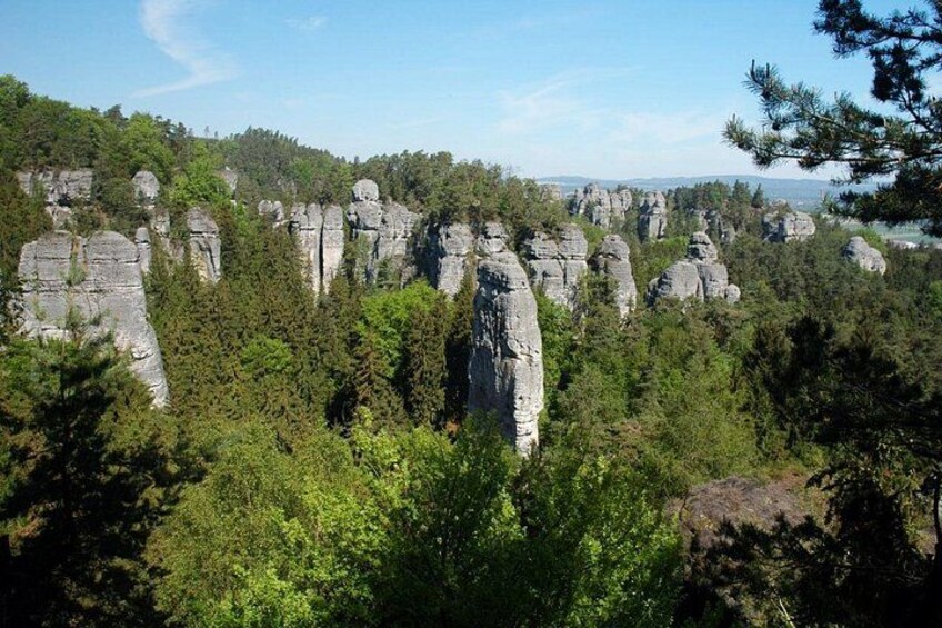 A forested landscape with numerous rock formations. 4