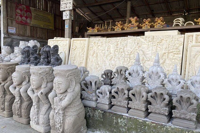 Intricately carved stone statues and panels, likely for decorative or religious purposes, displayed outdoors. 5