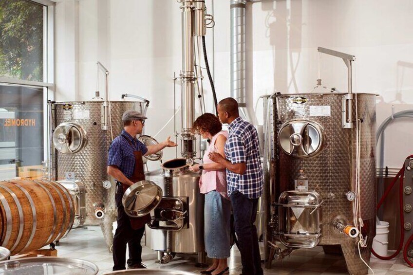 A brewery with stainless steel tanks and a wooden barrel. 4
