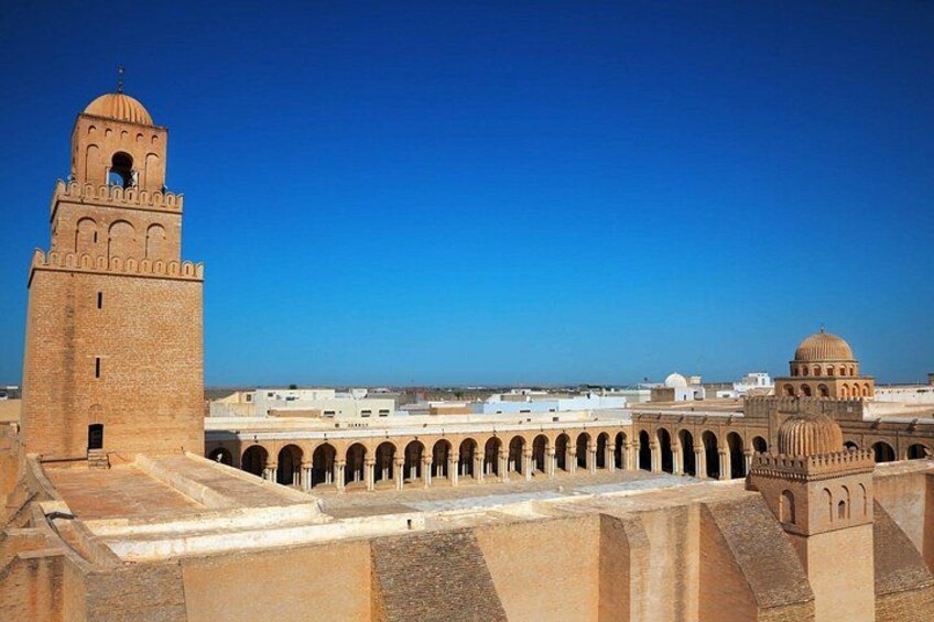 A historic fortress with a prominent tower and a dome, surrounded by a series of arches. 2