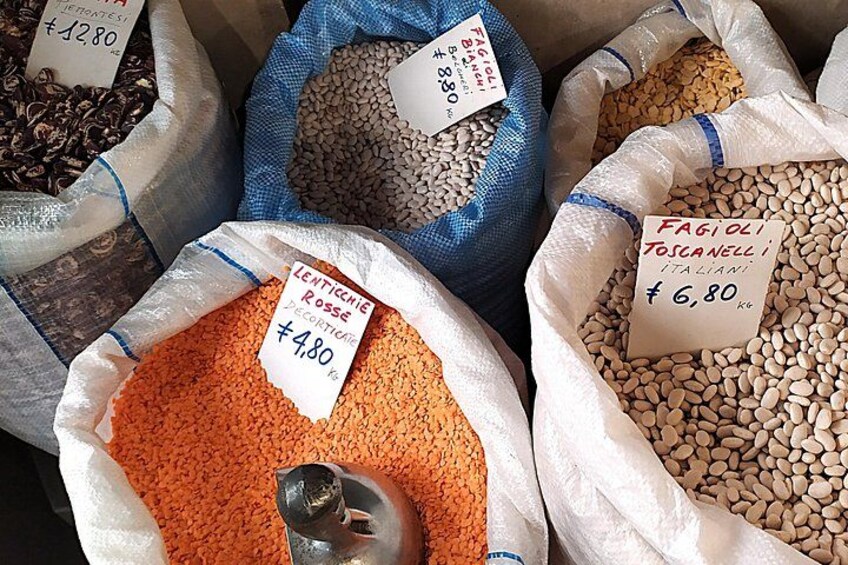 Bags of lentils, fagioli, and other legumes with price tags. 2