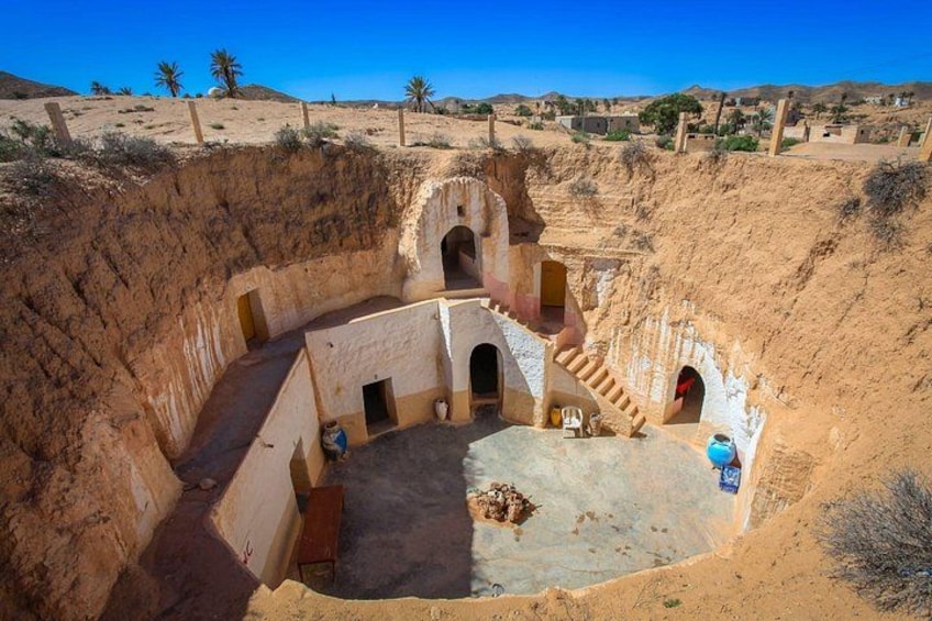 A traditional mud-brick structure with multiple doorways and a central courtyard. 2