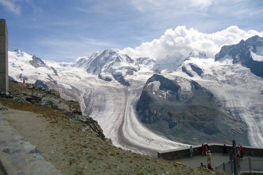A glacier with a road, rocky terrain, and a mountainous landscape. 2