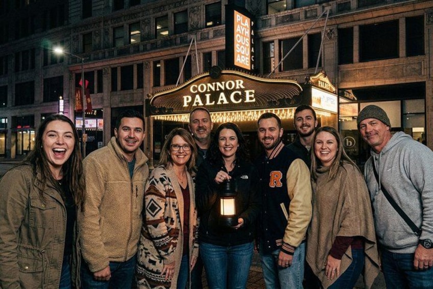 A group of people standing in front of a theater with a marquee that reads 'CONNOR PALACE.' 2