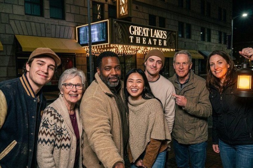 A group of people standing in front of the Great Lakes Theater. 1