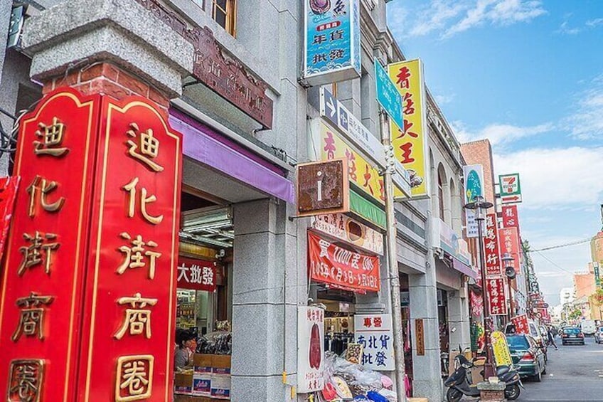 A street lined with shops and signs in a foreign language. 3