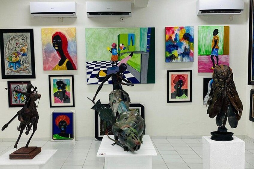 An art gallery with various paintings and sculptures on display. 2