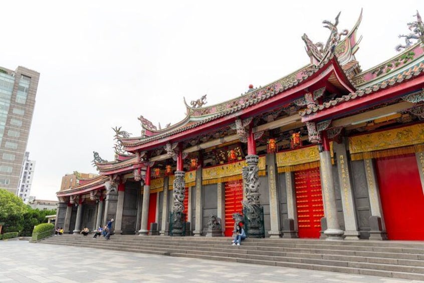A traditional Chinese temple with ornate architecture, red doors, and columns. 3
