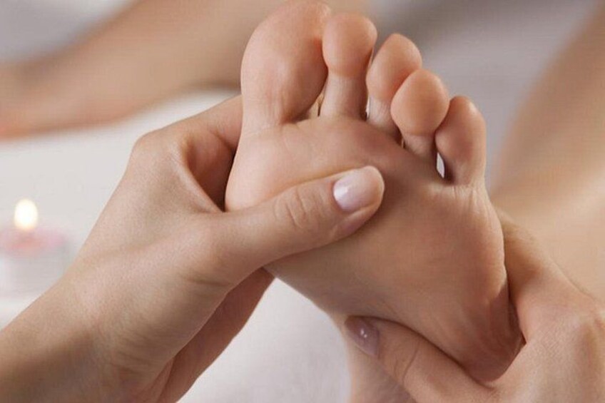 A close-up of hands holding and examining a foot. 2