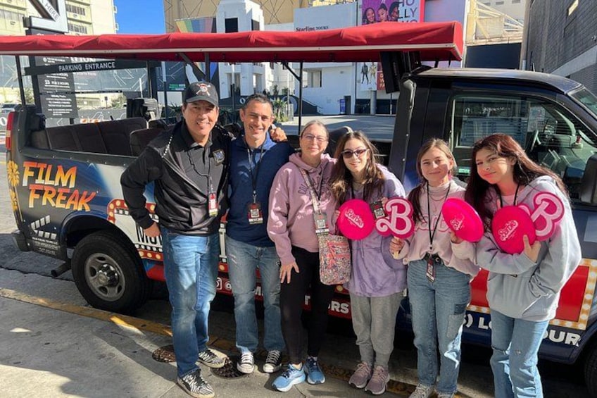 A group of people standing in front of a food truck with a red awning and a sign that reads 'FILM FREAK.' 5