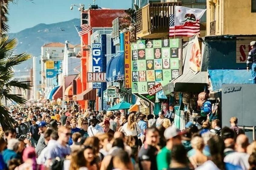 A crowded street with various colorful signs and flags. 2