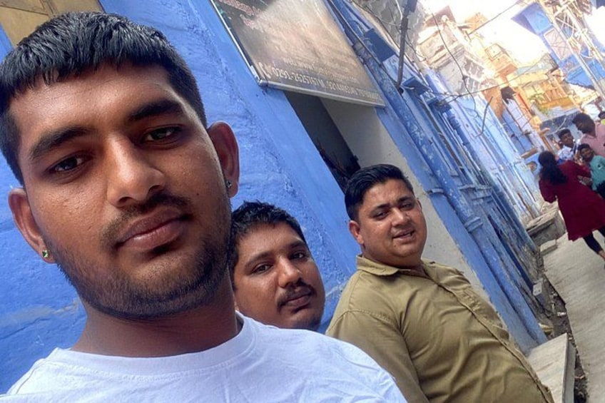 A street with blue buildings and a person in a white shirt. 5