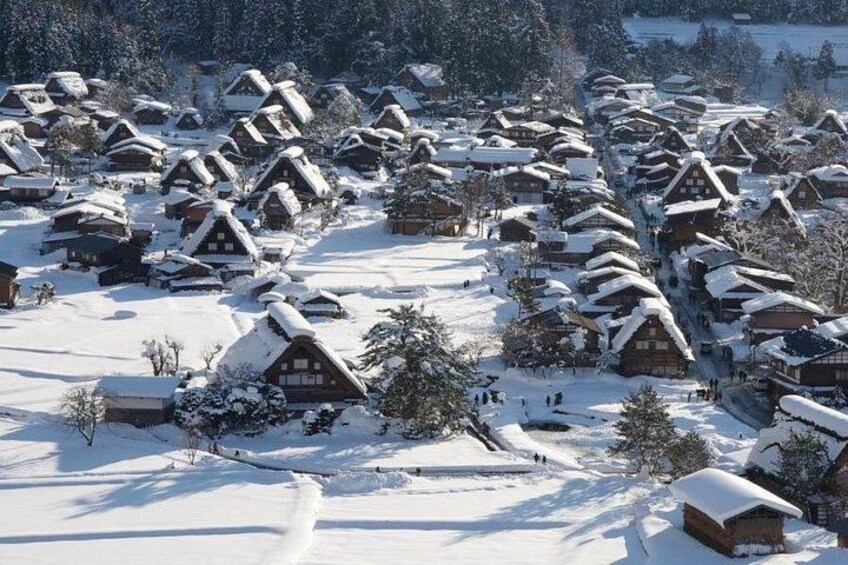 A snow-covered village with traditional wooden houses. 5