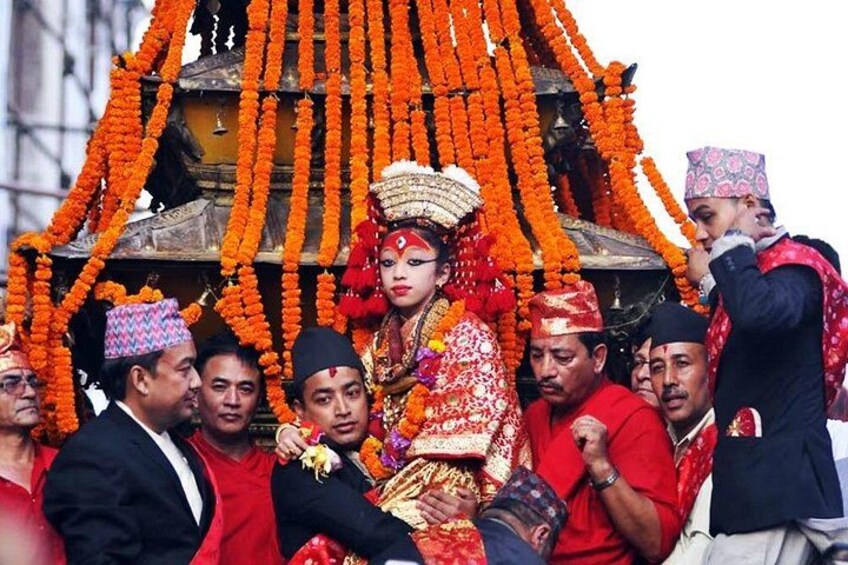 A group of people in traditional attire, a decorated structure, and a person in a red outfit. 2