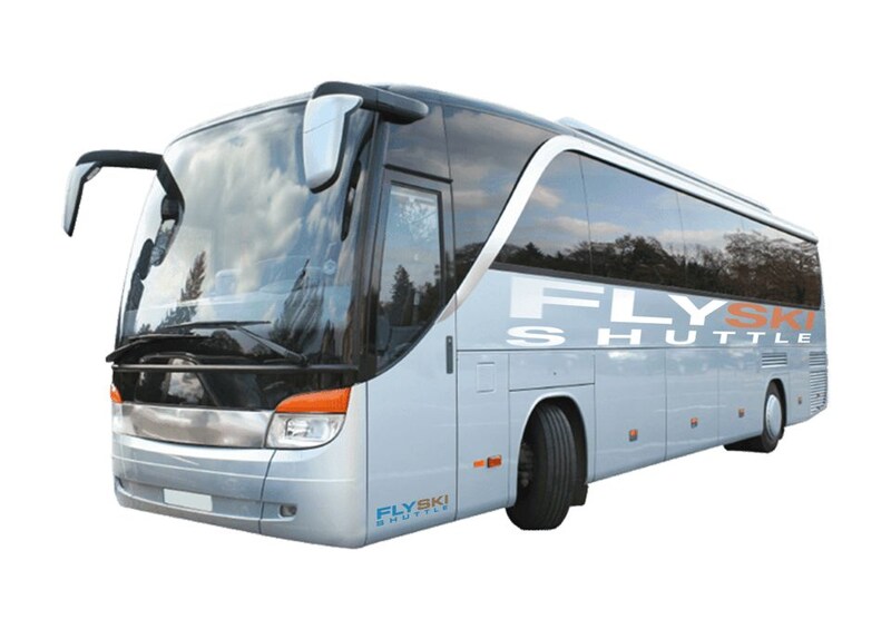 A silver FlySki Shuttle bus with a large windshield and side mirrors. 2
