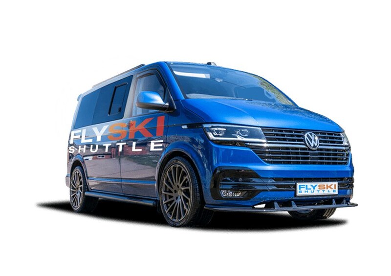 A blue Volkswagen van with 'FLY SKI SHUTTLE' branding. 3