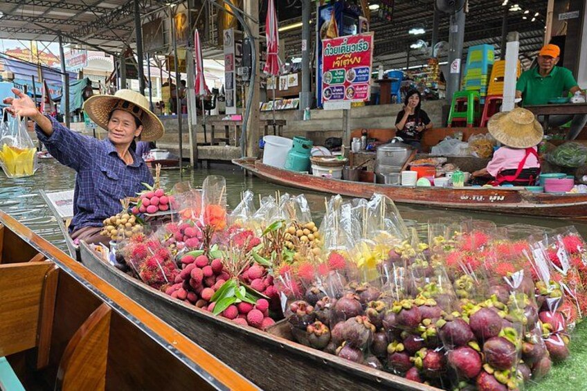 A floating market with boats filled with fruits and vegetables. 3