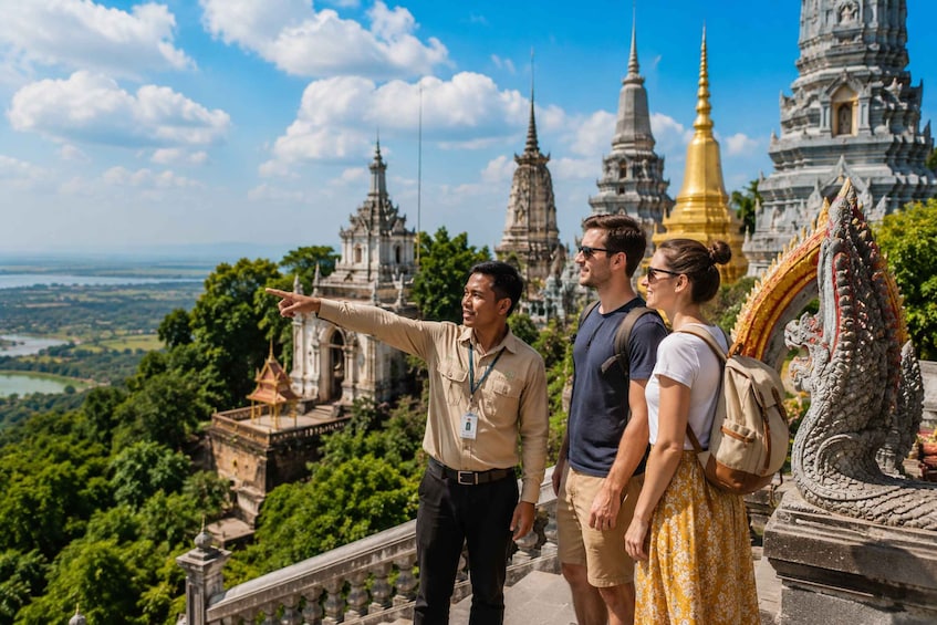 Tourists on a viewing platform overlooking ancient temples and lush greenery. 2